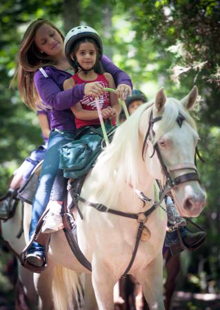 Child Riding Double with a Guide